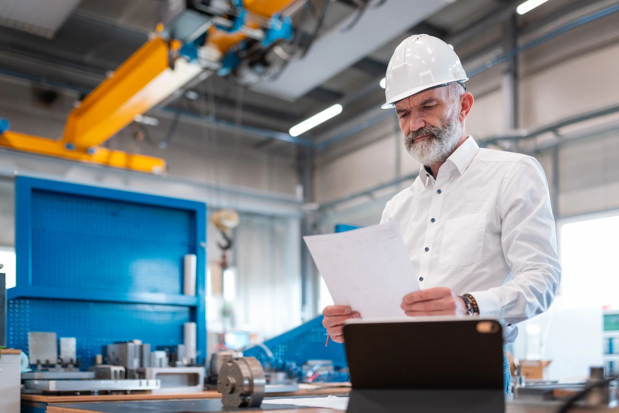 Engineer reviewing a process plan in a manufacturing environment